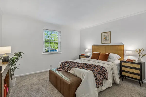 a bedroom with a bed and a lamp with the wooden floor