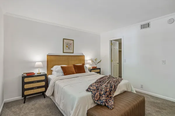 a bed sitting in a bedroom next to a window