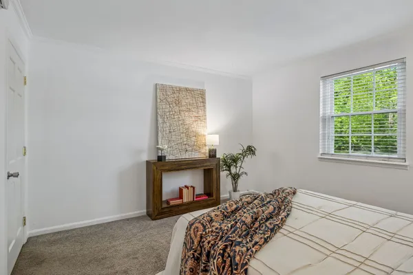 a bathroom with a granite countertop sink a toilet and shower