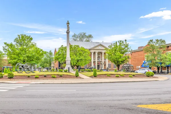 a view of a building with car parked