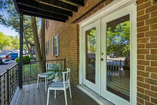 a view of a chair and table in the balcony