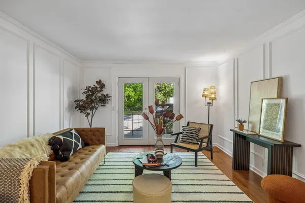 a living room with furniture and a wooden floor