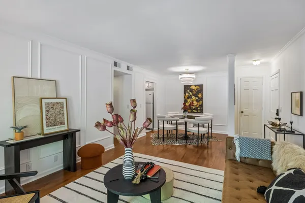 a living room with furniture and wooden floor