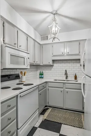 a kitchen with stainless steel appliances a sink stove and refrigerator