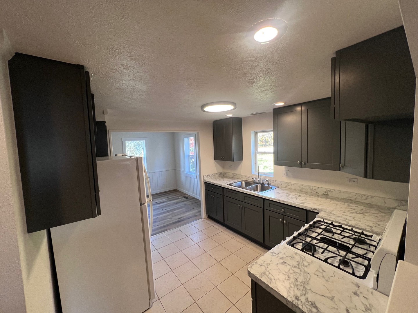14707 Caledonia Road Caledonia, IL 61011 - Photo 21 of 37 a kitchen with stainless steel appliances granite countertop a refrigerator and a stove top oven