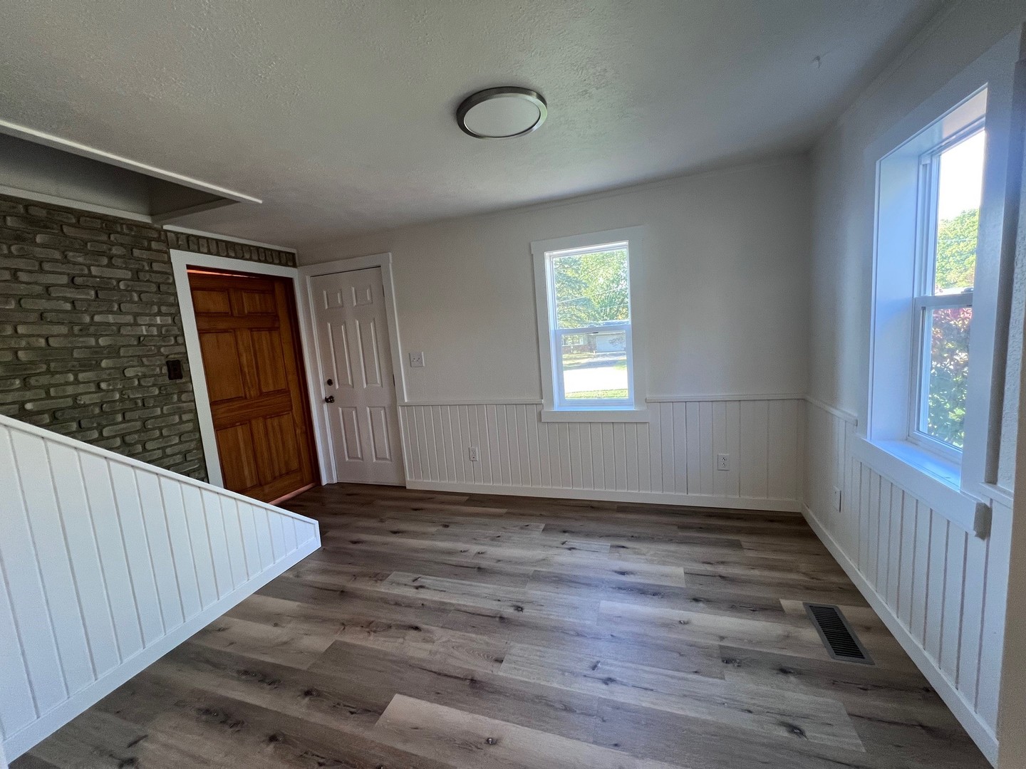 14707 Caledonia Road Caledonia, IL 61011 - Photo 22 of 37 a view of an empty room with wooden floor and a window
