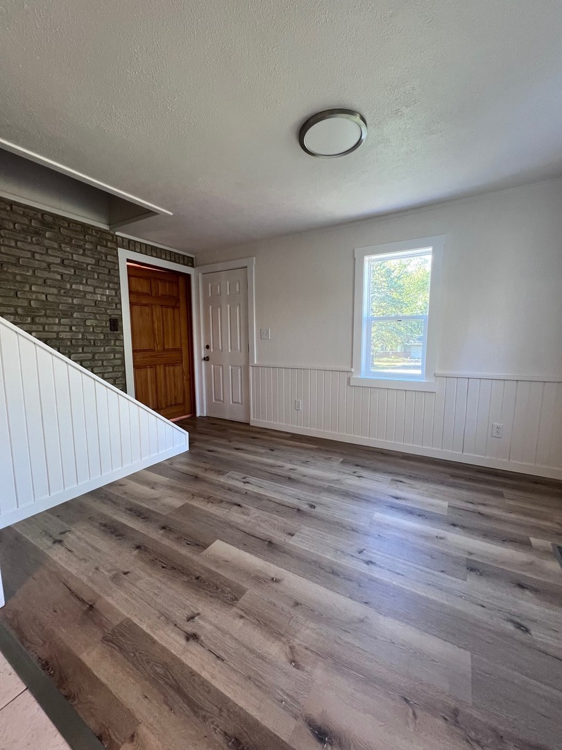 14707 Caledonia Road Caledonia, IL 61011 - Photo 23 of 37 a view of an empty room with wooden floor and a window