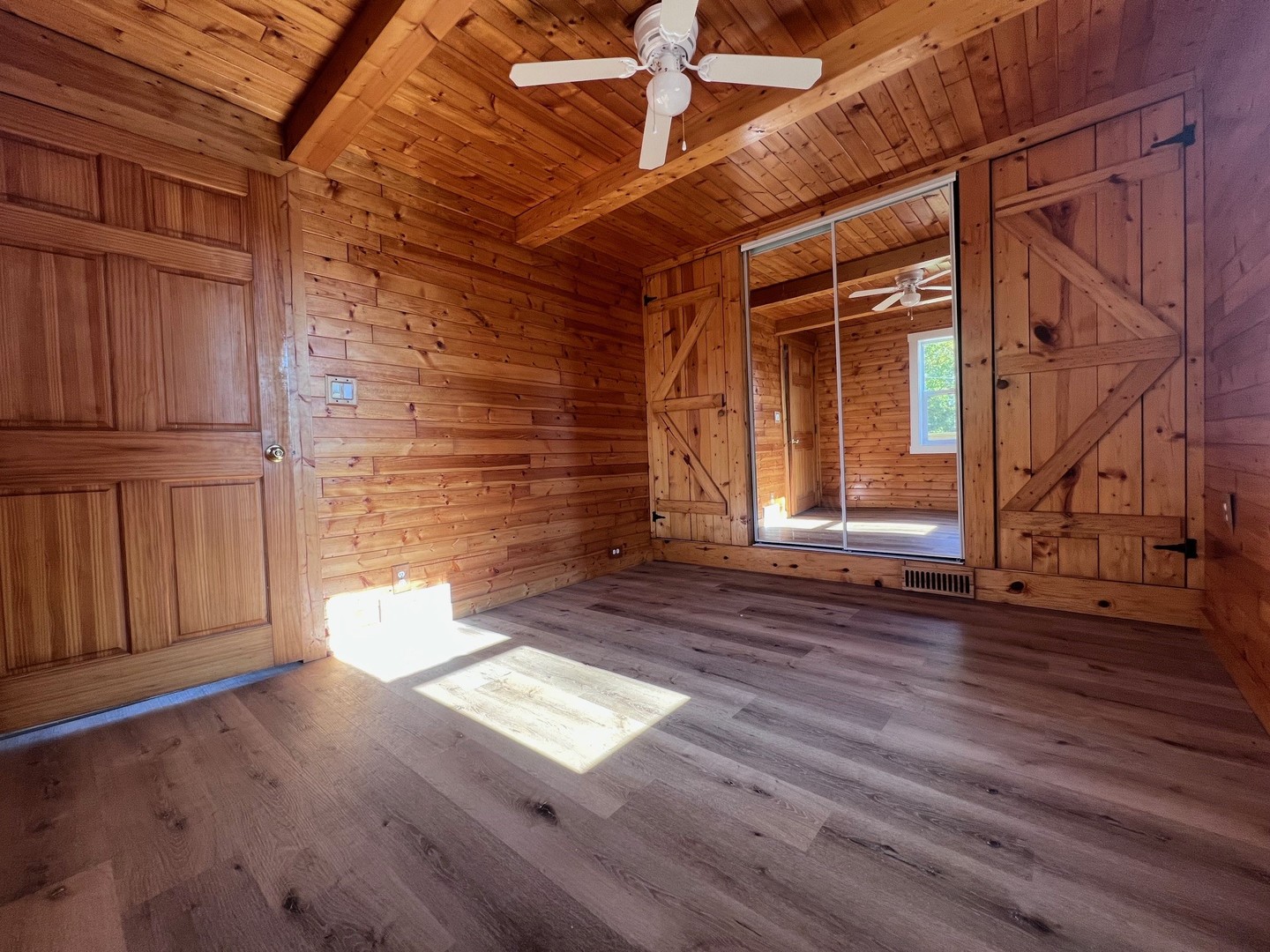 14707 Caledonia Road Caledonia, IL 61011 - Photo 27 of 37 a view of empty room with wooden floor and fan
