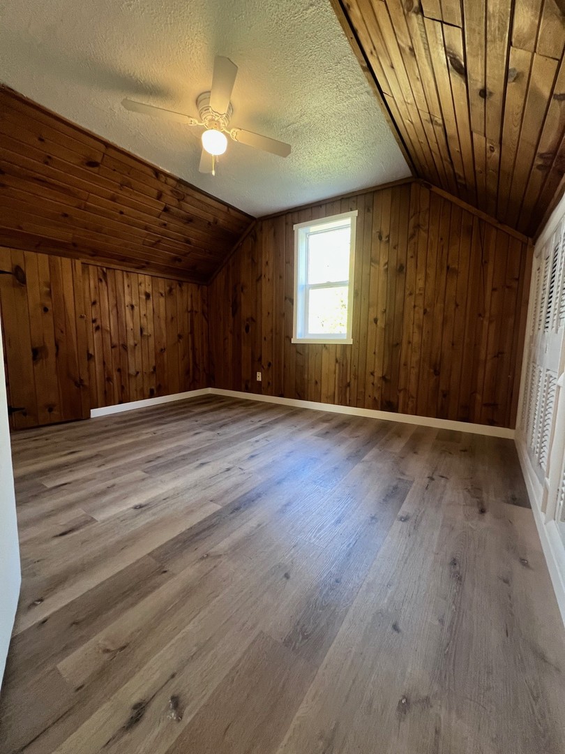14707 Caledonia Road Caledonia, IL 61011 - Photo 32 of 37 an empty room with wooden floor and windows
