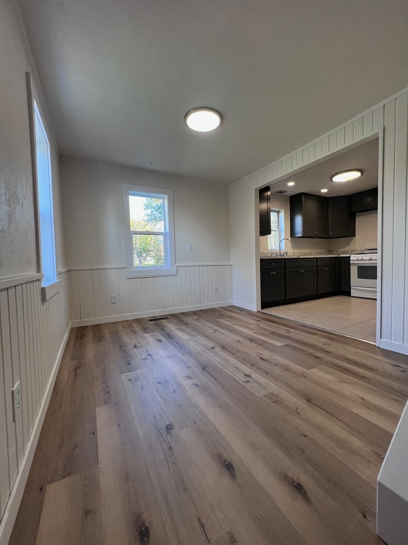 14707 Caledonia Road Caledonia, IL 61011 - Photo 6 of 37 an empty room with wooden floor and windows