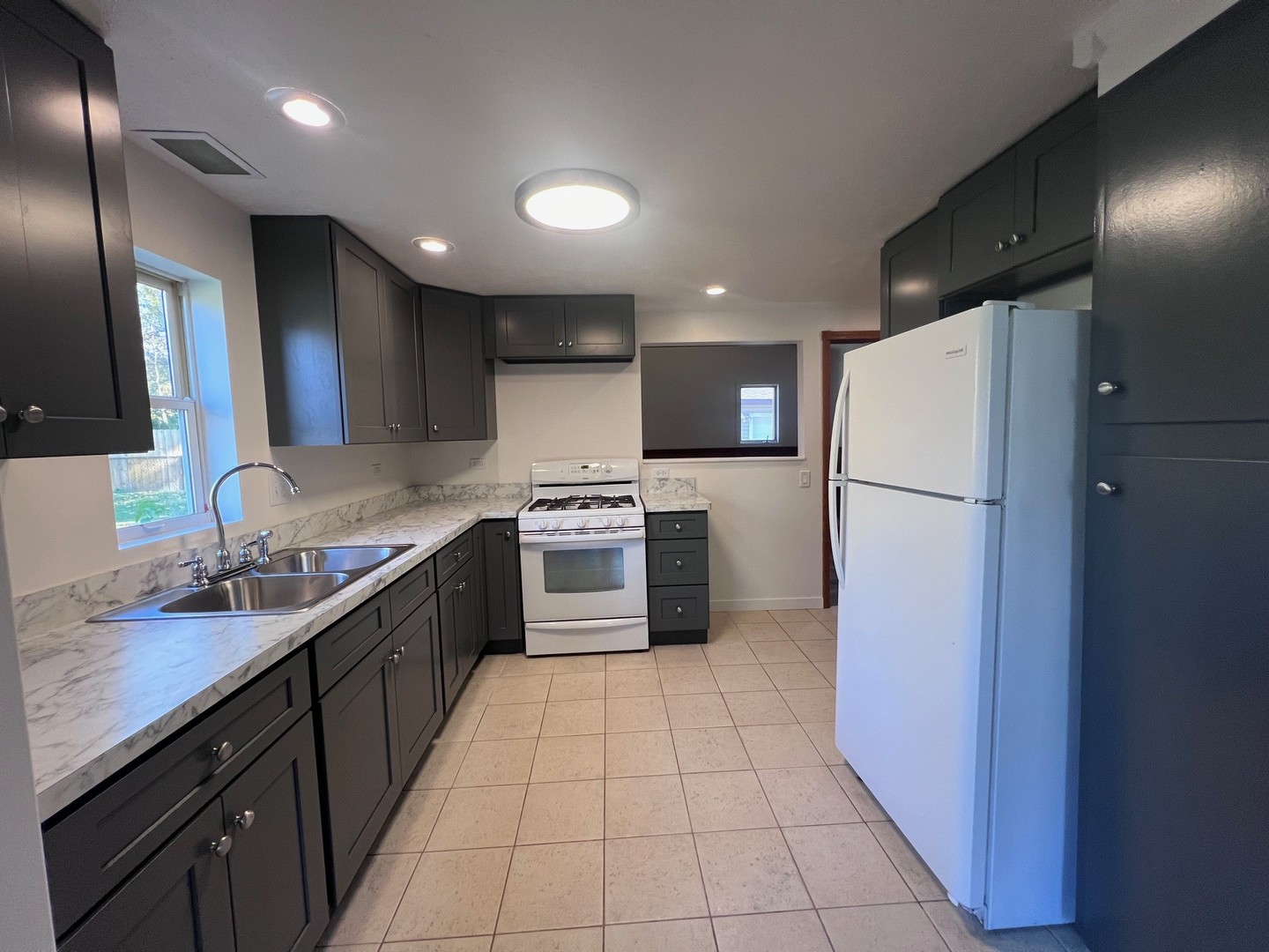 14707 Caledonia Road Caledonia, IL 61011 - Photo 7 of 37 a kitchen with a refrigerator a sink and dishwasher