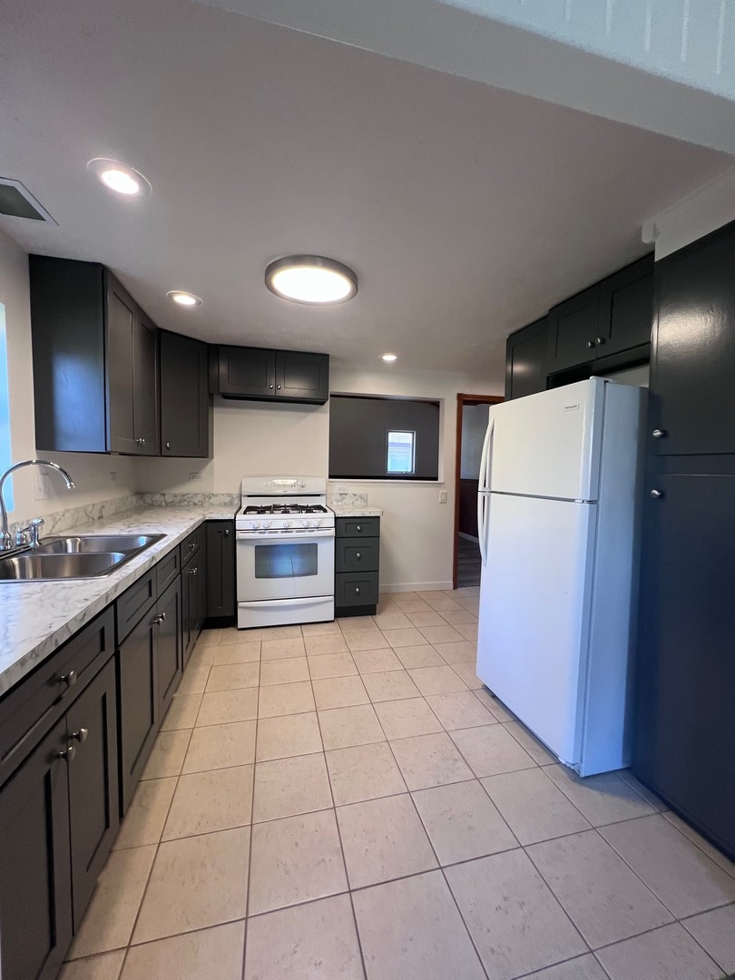 14707 Caledonia Road Caledonia, IL 61011 - Photo 8 of 37 a large kitchen with a large counter top appliances and cabinets