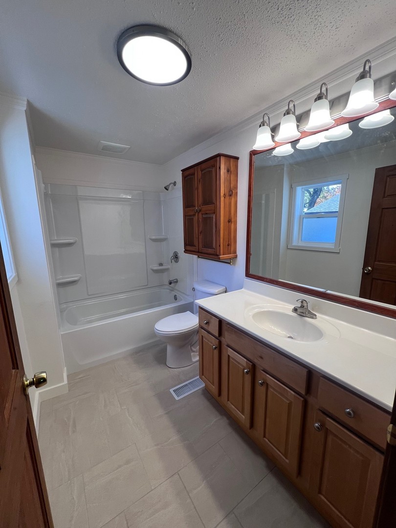 14707 Caledonia Road Caledonia, IL 61011 - Photo 9 of 37 a bathroom with a sink double vanity granite and a mirror