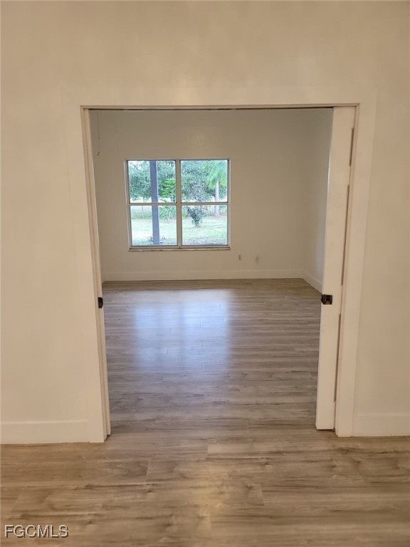 7820 Rich Road North Fort Myers, FL 33917 - Photo 15 of 26 a view of an empty room with wooden floor and a window