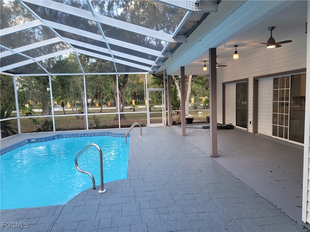 7820 Rich Road North Fort Myers, FL 33917 - Photo 24 of 26 a view of a hall with floor to ceiling windows