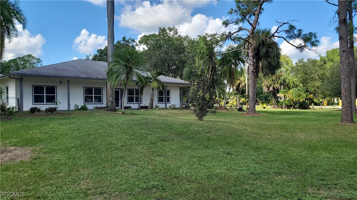7820 Rich Road North Fort Myers, FL 33917 - Photo 7 of 26 a view of house in front of a big yard with large trees