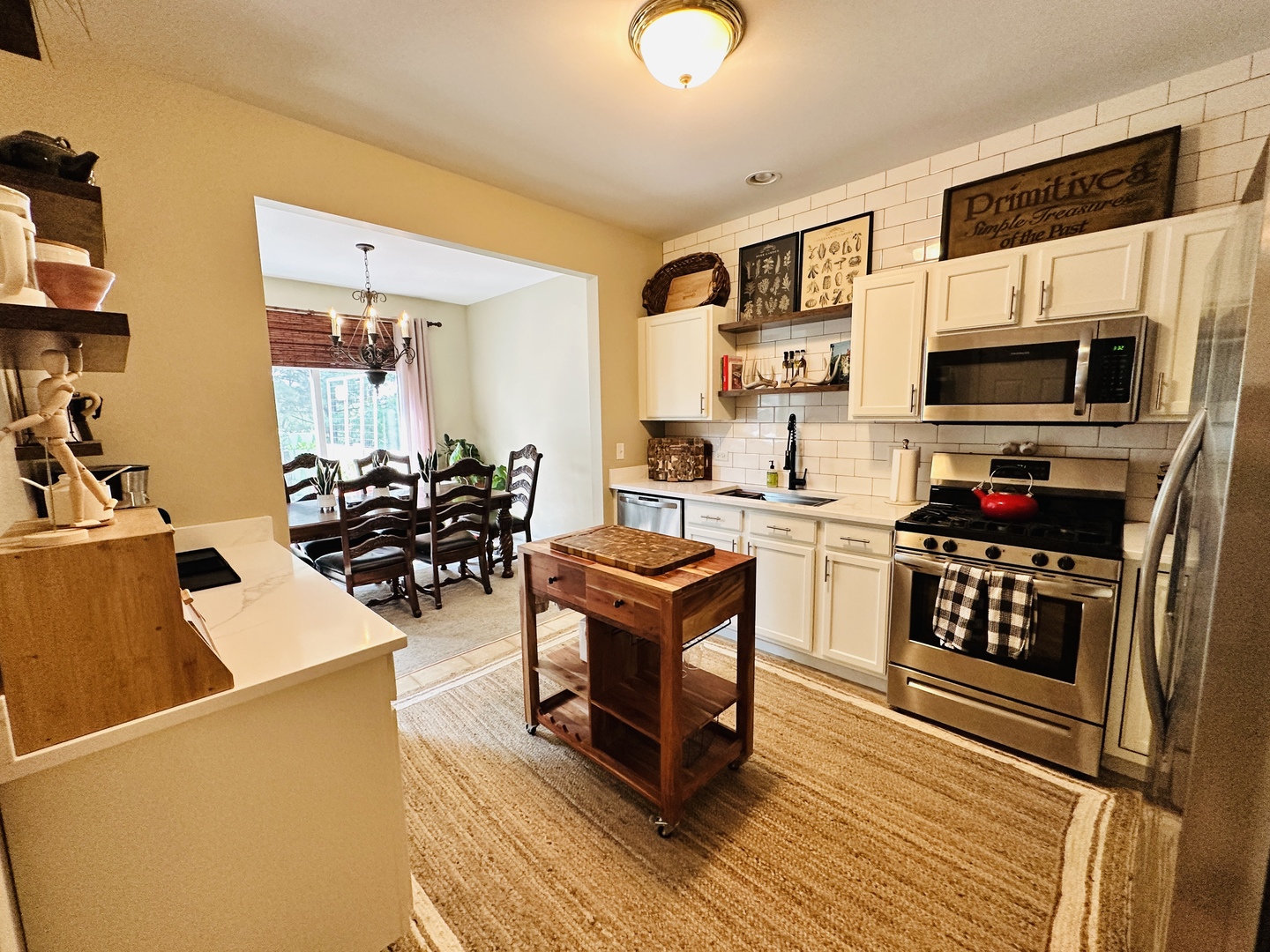 963 Oak Ridge Boulevard Elgin, IL 60120 - Photo 7 of 29 a living room with stainless steel appliances kitchen island granite countertop a stove a sink dishwasher and a microwave oven with wooden floor