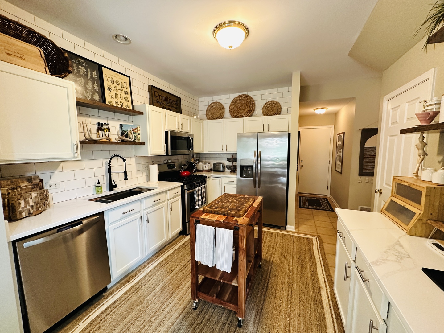 963 Oak Ridge Boulevard Elgin, IL 60120 - Photo 9 of 29 a kitchen with stainless steel appliances a stove a sink a microwave a refrigerator and cabinets