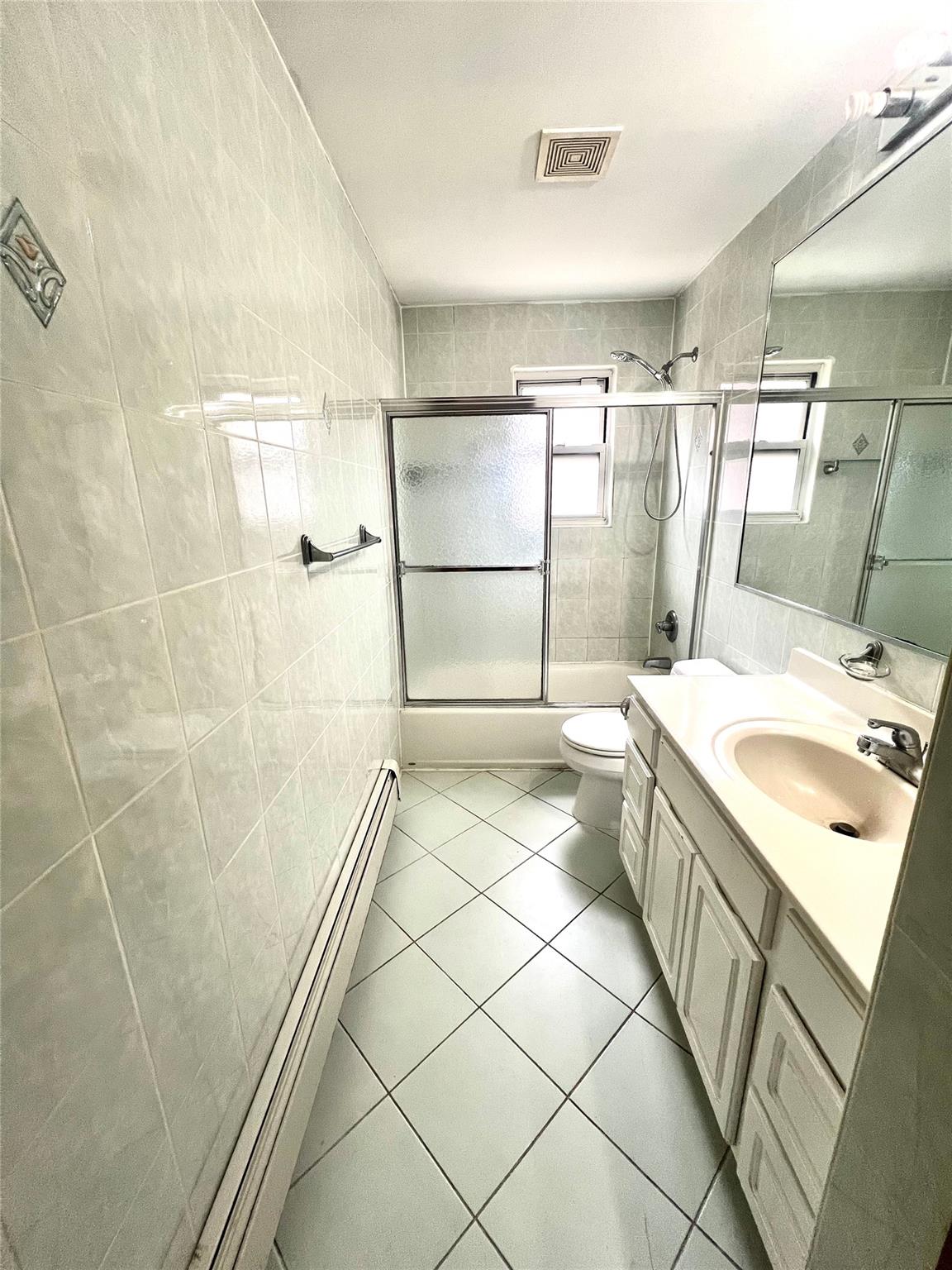 200-29 45th Road, Unit 2 Queens, NY 11361 - Photo 5 of 14 a bathroom with a sink a toilet and shower