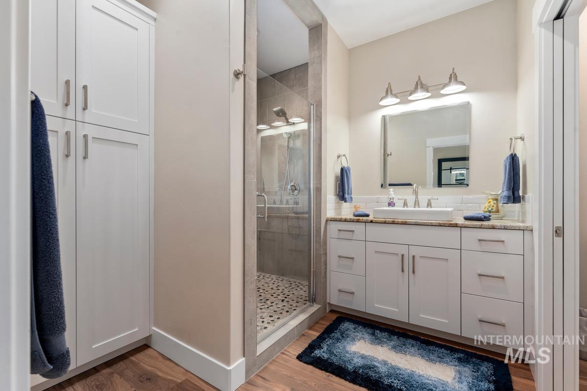 21 Open Road Garden Valley, ID 83622 - Photo 19 of 49 Bathroom featuring vanity, a stall shower, and light wood-type flooring