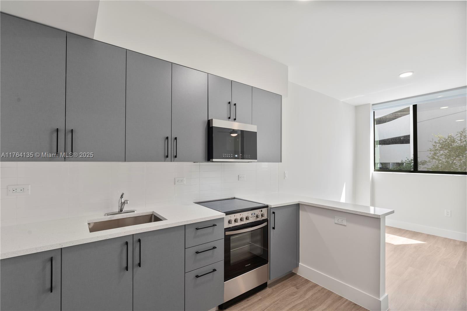 a kitchen with a sink and a stove top oven
