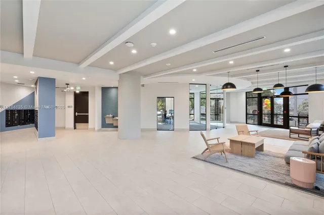 a large white kitchen with a large window and stainless steel appliances
