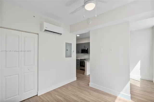 a view of a kitchen with a sink and a refrigerator