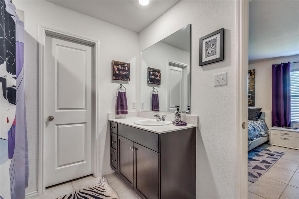 7733 Ruellia Road McKinney, TX 75071 - Photo 9 of 19 Ensuite bathroom with tile patterned floors and vanity