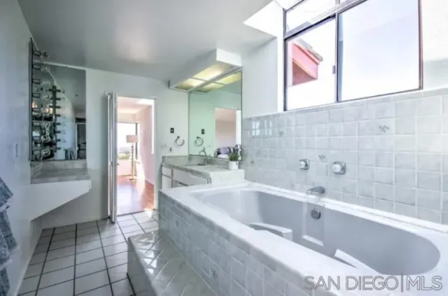 a bathroom with a sink and mirror