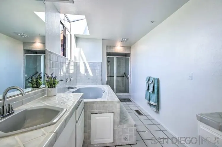 404 Hidden Valley Road Watsonville, CA 95076 - Photo 13 of 69 a bathroom with a sink and mirror