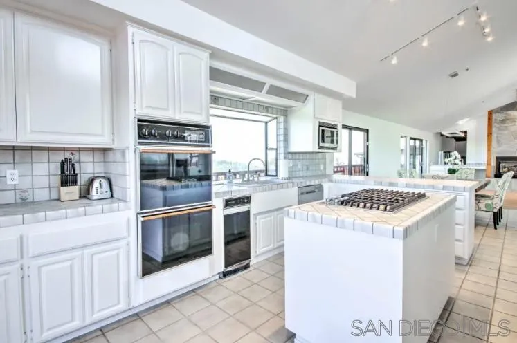 404 Hidden Valley Road Watsonville, CA 95076 - Photo 15 of 69 a kitchen with granite countertop a sink a stove a washer and dryer