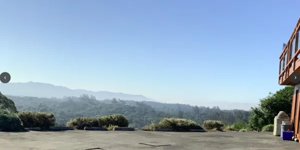 a spacious bedroom with a bed and a large window