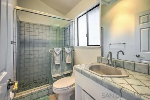 a bathroom with a sink toilet and shower