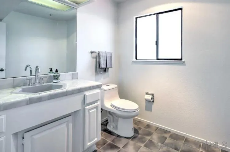 404 Hidden Valley Road Watsonville, CA 95076 - Photo 49 of 69 a bathroom with a sink toilet and mirror