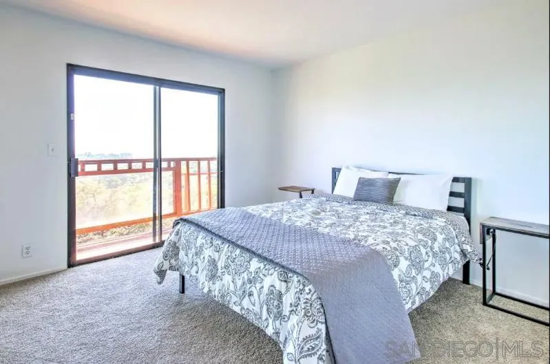 404 Hidden Valley Road Watsonville, CA 95076 - Photo 51 of 69 a bedroom with a large bed and a large window