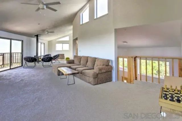 an empty room with large window and wooden floor