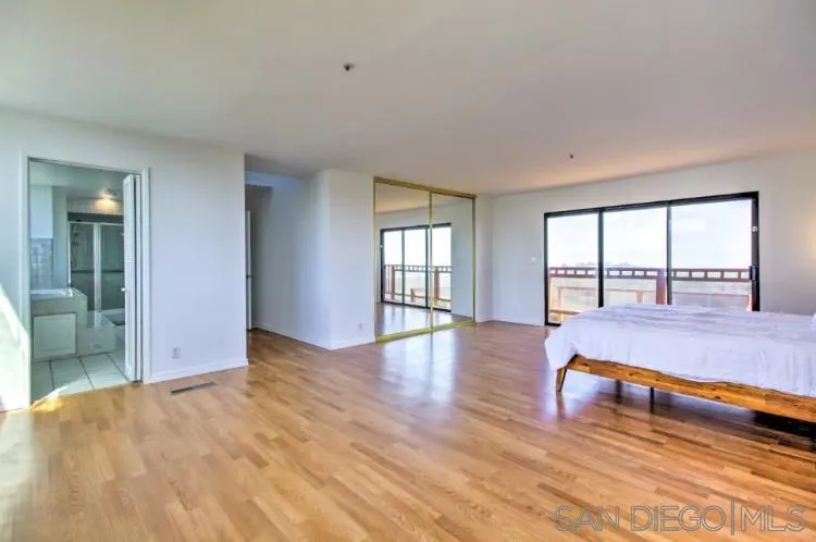 404 Hidden Valley Road Watsonville, CA 95076 - Photo 10 of 69 an empty room with large window and wooden floor