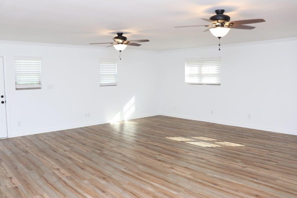 6431 Old Bottom Road Pleasant Shade, TN 37145 - Photo 11 of 38 a view of a room with a ceiling fan a ceiling fan and wooden floor