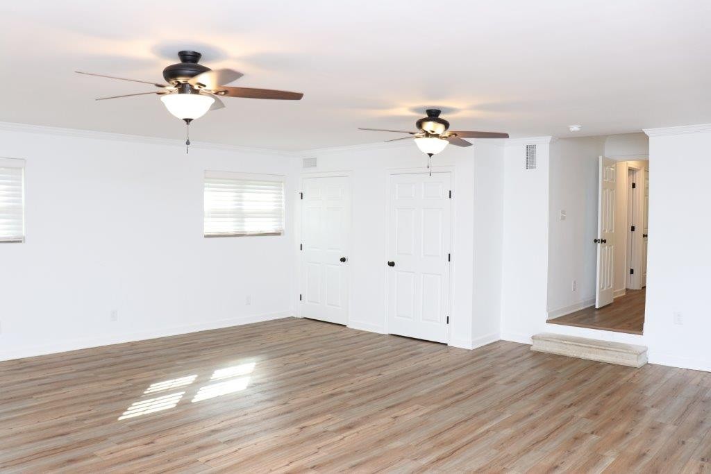 6431 Old Bottom Road Pleasant Shade, TN 37145 - Photo 12 of 38 a view of a room with wooden floor and a ceiling fan