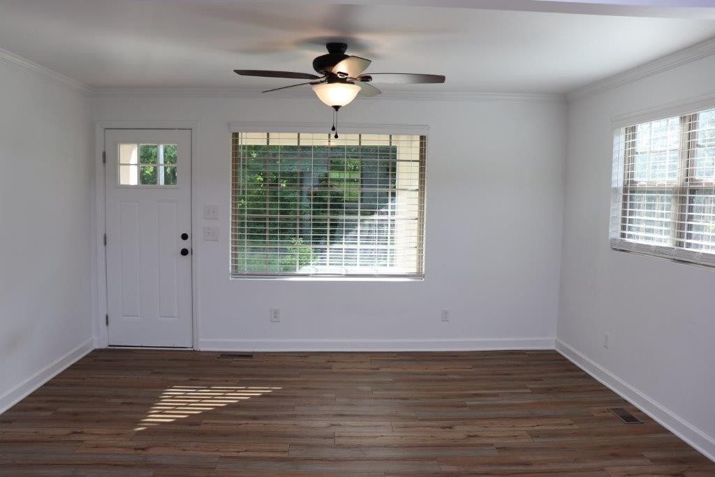 6431 Old Bottom Road Pleasant Shade, TN 37145 - Photo 5 of 38 a view of an empty room with wooden floor and a window