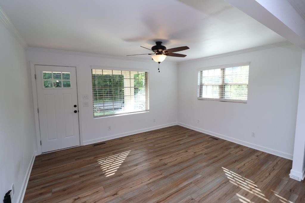 6431 Old Bottom Road Pleasant Shade, TN 37145 - Photo 6 of 38 a view of an empty room with wooden floor and a window