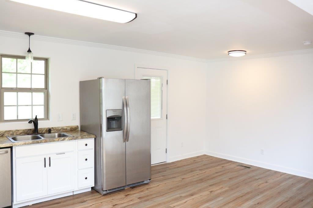 6431 Old Bottom Road Pleasant Shade, TN 37145 - Photo 8 of 38 a kitchen with granite countertop a refrigerator and a sink