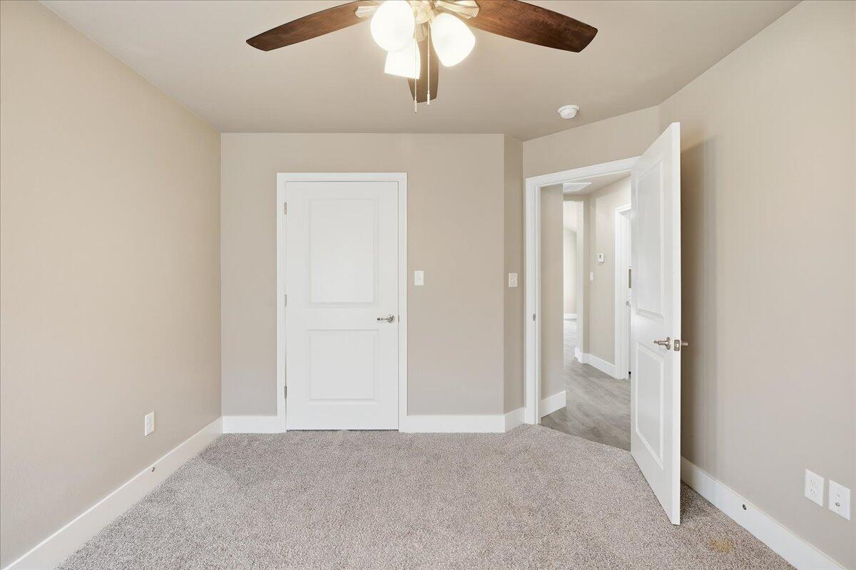 7502 89th Street Lubbock, TX 79424 - Photo 19 of 26 an empty room with chandelier fan