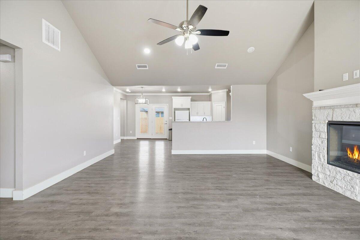7502 89th Street Lubbock, TX 79424 - Photo 2 of 26 a view of an empty room with window and wooden floor