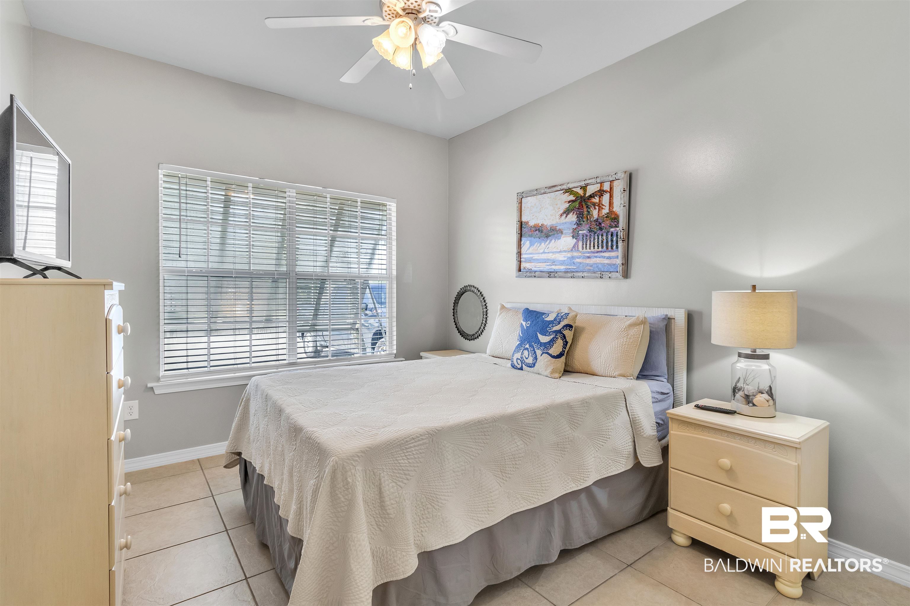 4324 B Lindsey Lane, Unit 4324B Orange Beach, AL 36561 - Photo 15 of 33 Bedroom featuring a ceiling fan, baseboards, and light tile patterned floors