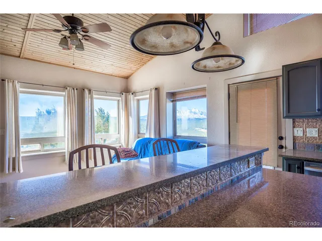 a view of living room kitchen with furniture and fireplace