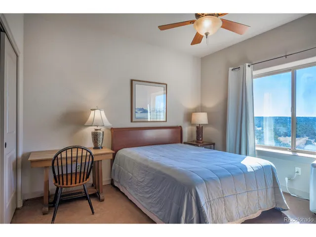 a bedroom with a bed a window and walk in closet