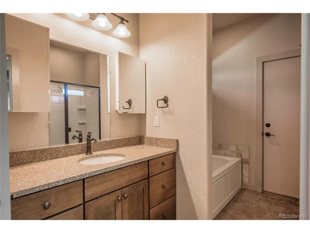a bathroom with a sink a mirror and a bathtub
