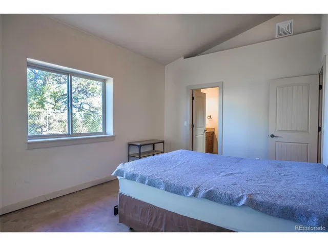 a bedroom with a bed and window