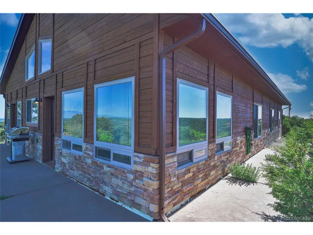 a view of a porch with furniture and floor to ceiling window